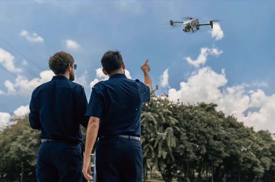 Zwei Polizeikräfte verfolgen den Flug einer Alpha